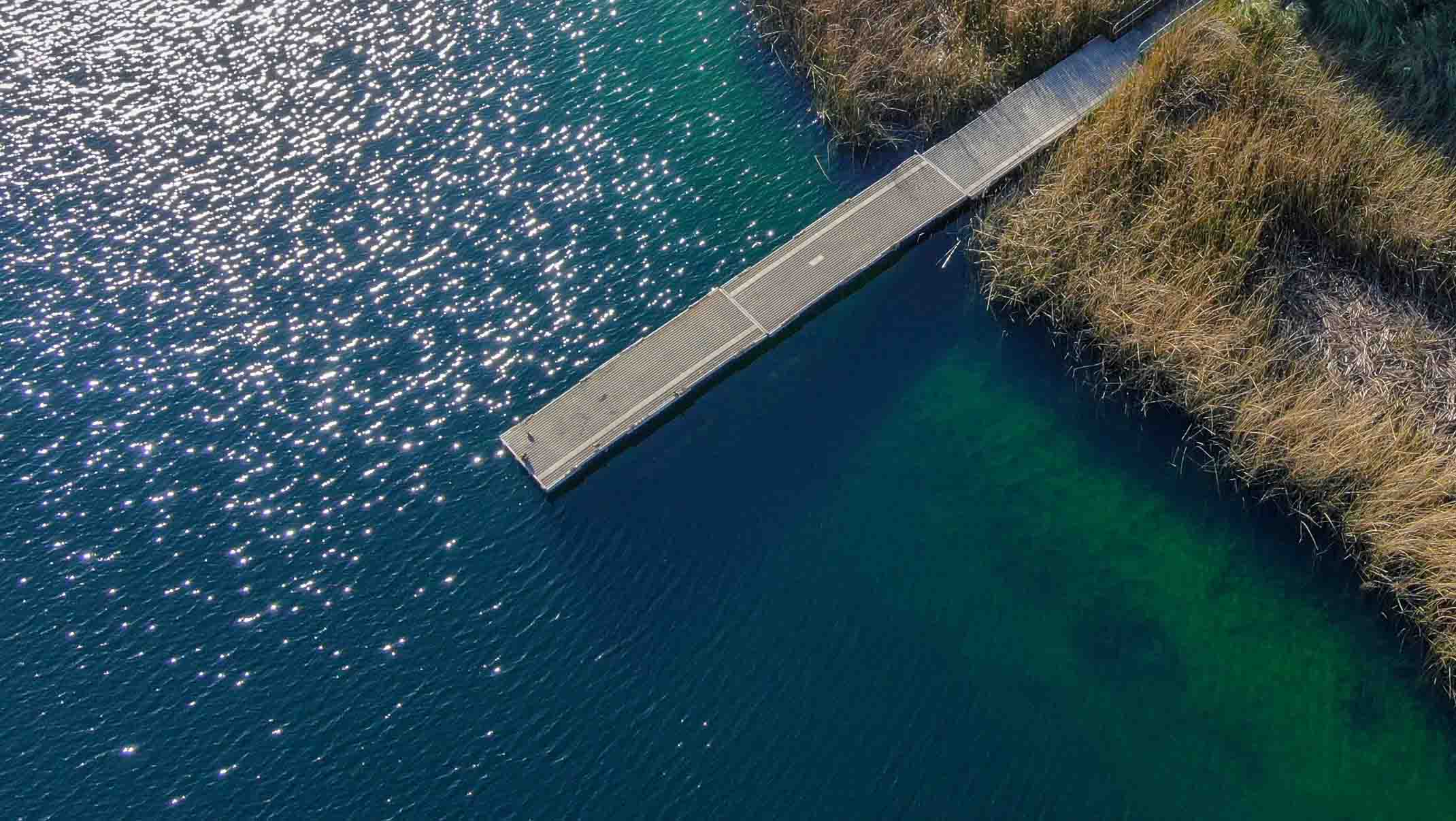 Aerial view of a wooden pier in a body of water