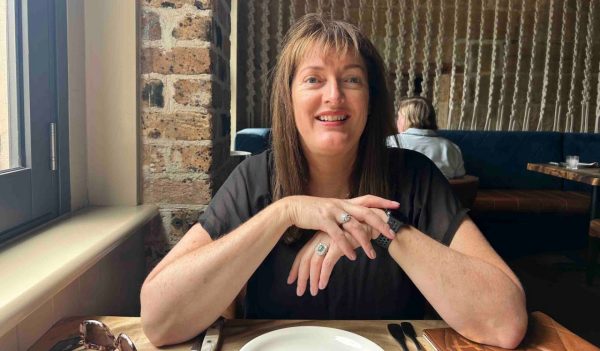 Liz Cadogan sitting at table in restaurant.