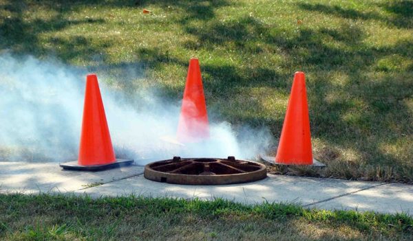 Safety pylons around open manhole