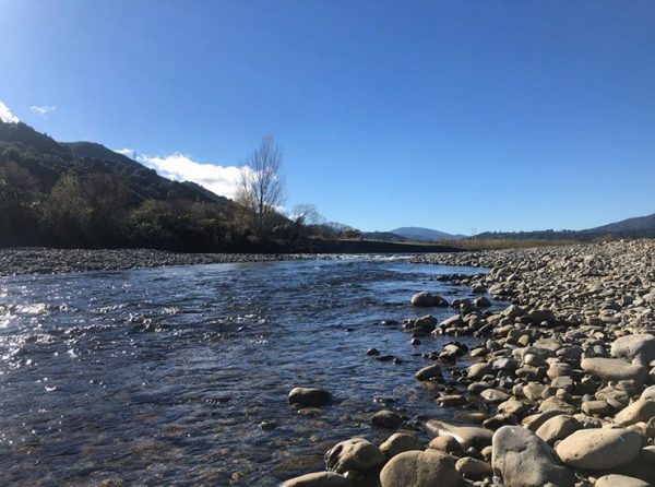 stream with rocks, blue sky