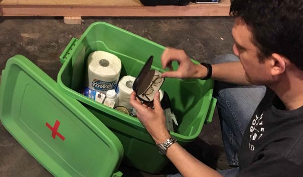 Person looking through an emergency preparedness kit.