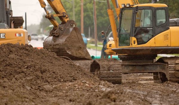 Backhoe digging in a trench