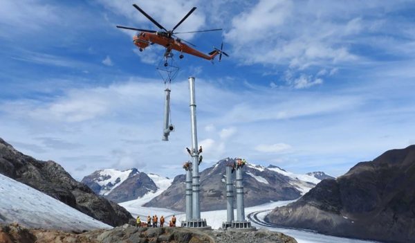 helicopter setting poles on hill