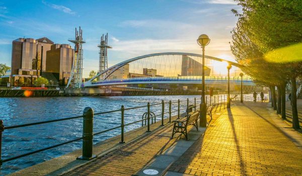 View of a footbridge in Salford quays in Manchester, England at sunset