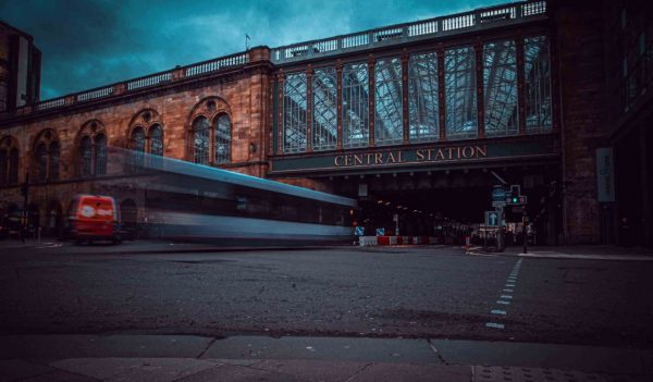 Glasgow central station with bus trails on overcast day in summer