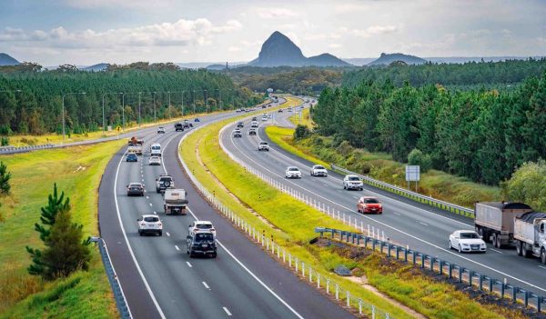 Queensland, Australia - Cars moving along Bruce Hwy with Glass House mountains in the background