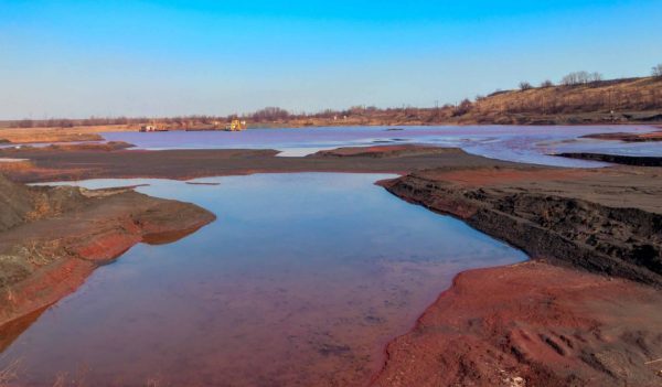 Red water polluted with iron ore waste.