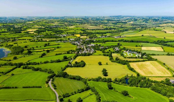 Aerial drone view of green fields and farmland in rural Wales