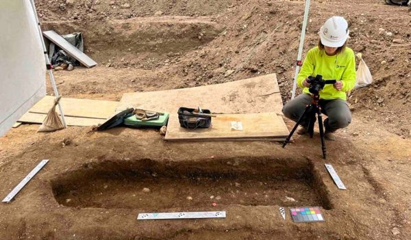 Environmental scientist using equipment ot make a 3D model of the skeletal remains.