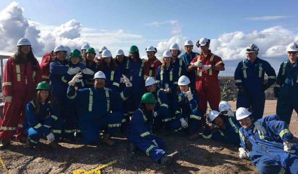 Imperial’s Mine contracts and business planning superintendent and field engineer stand for a picture with the group at Kearl.