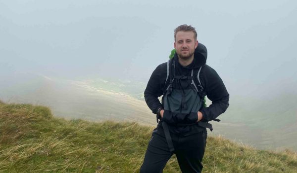 Alex Prance standing on a hill.