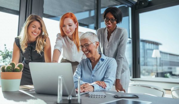 Businesswomen working together in the office on a project. 