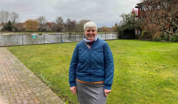 Sharon standing outside with a canal in the background.