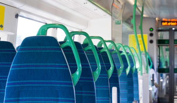 Light panoramic view interior of a high speed electric modern train with blue seats