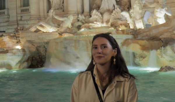 Emily Carroll standing in front of a historic fountain.