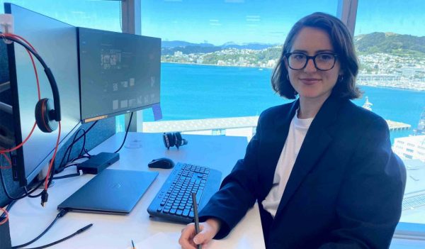 Jewelia Podmore sitting at her desk in the office.