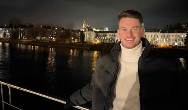 Josh Checkly at night with buildings behind him.