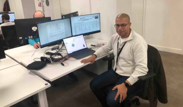 Othmane El Mountassir sitting at his desk in the office.