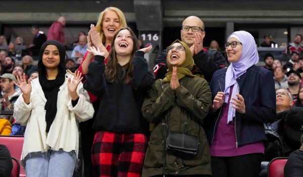 Group image of the bursary winners at an Ottawa Senators game with Stantec.'s Dylan Hemmings.