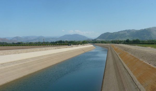 A canal with mountains in the background