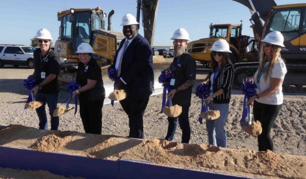 People with shovels on site for the groundbreaking ceremony