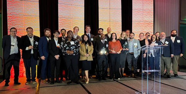 Group image of award recipients on stage.