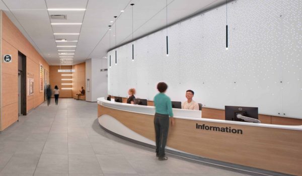 A large curved information desk with people and a corridor. Image credit: David Wakley