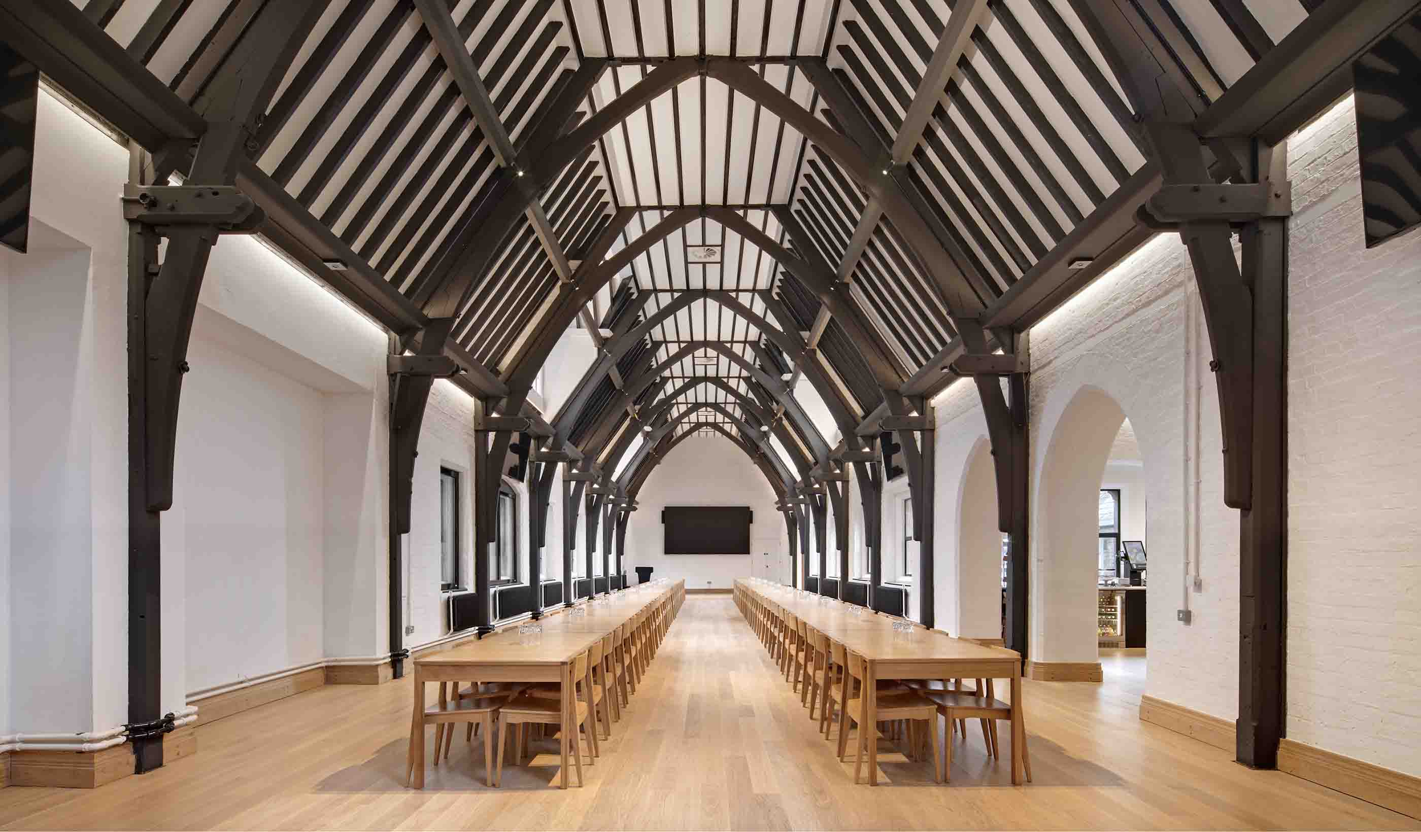 Study space with tables and chairs and vaulted ceiling