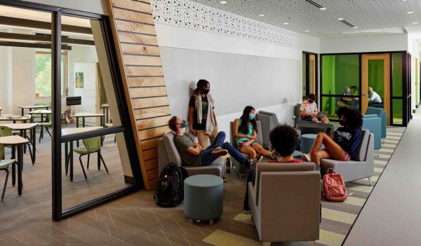 Students hanging out in a lounge area with chairs.