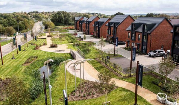 A pathway with plantings and homes