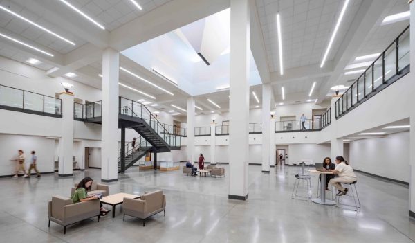 Interior open area with stairs and views to upper floors, and seating