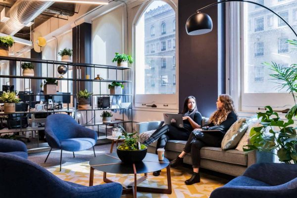 People sitting on a couch in a casual office setting