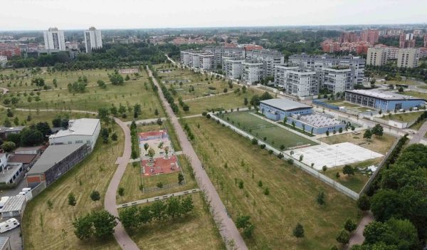 Drone view of Sei Milano, new GARDEN CITY  in the western suburbs near Bisceglie subway. Urban regeneration project and green revolution - the park near the new skyscrapers site