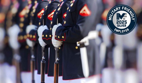 Military people standing at attention with Military Friendly logo