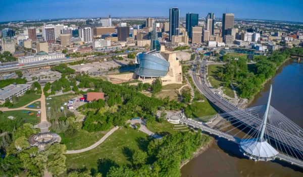 Aerial view of downtown Winnipeg, Manitoba with buildings, bridges, a river and park